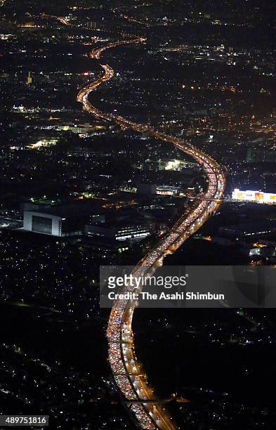 In this aerial image, a long queue of rear lamps of holiday goer cars are seen at Tomei Expressway on September 22, 2015 in Ebina, Kanagawa, Japan.