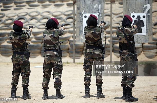 Female members of the Palestinian presidential guard take part in a training at the shooting range session given by French GIGN gendarme in the West...