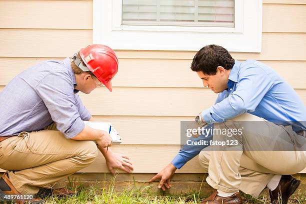 inspectors or blue collar workers examine building wall, foundation. outdoors. - building foundations stock pictures, royalty-free photos & images