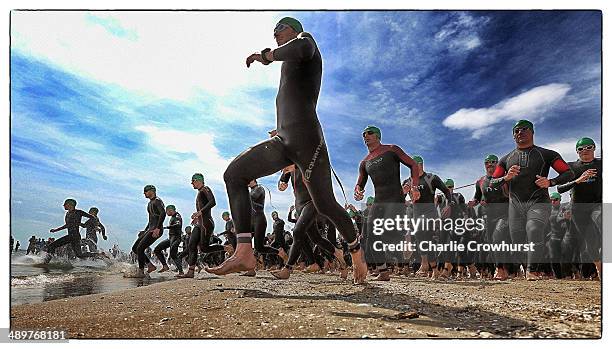 Participants enter the sea to begin the swim leg during the Challenge Triathlon Rimini on May 11, 2014 in Rimini, Italy.