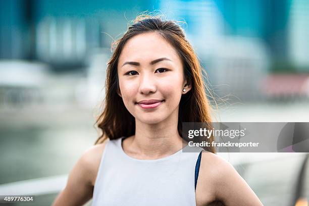 pretty asian woman standing outdoors - asian females stock pictures, royalty-free photos & images