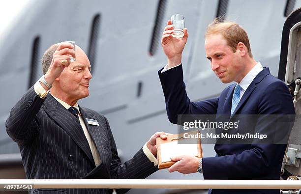 Prince William, Duke of Cambridge makes a toast with a tot of rum after touring the newly restored submarine HMS Alliance during a visit to the Royal...