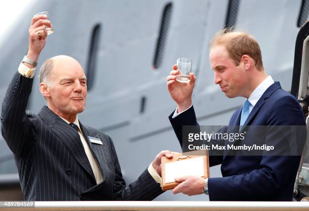 Prince William, Duke of Cambridge makes a toast with a tot of rum after touring the newly restored submarine HMS Alliance during a visit to the Royal...