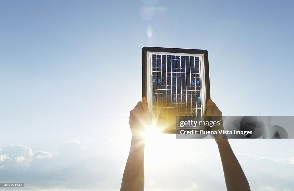 Woman hands with solar panel