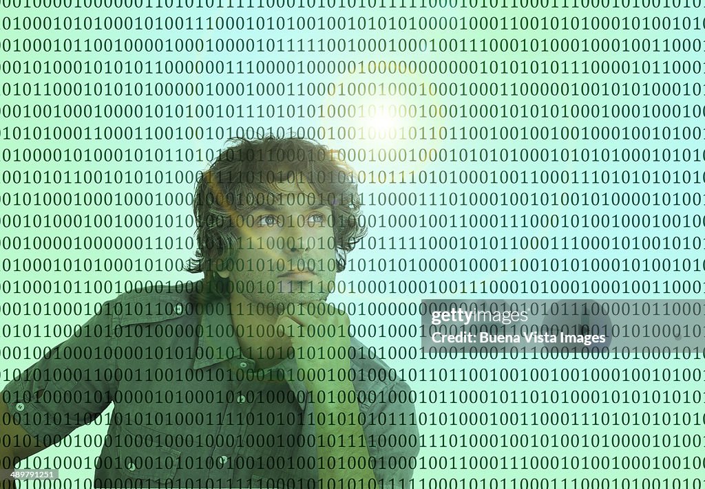 Thoughtful man in front of binary code