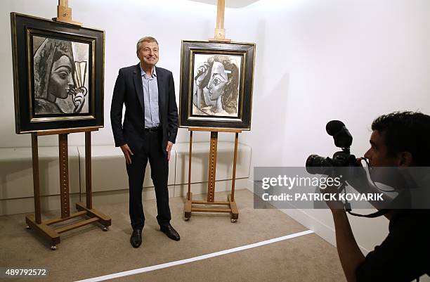 Russian businessperson and President of French football club AS Monaco Dmitry Rybolovlev poses in Paris on September 24, 2015 in front of two...