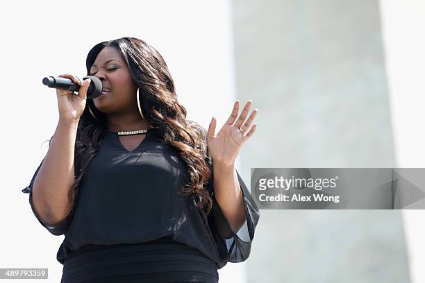 American Idol Winner Candice Glover sings the song America the Beautiful during a reopening ceremony for the Washington Monument May 12, 2014 in...