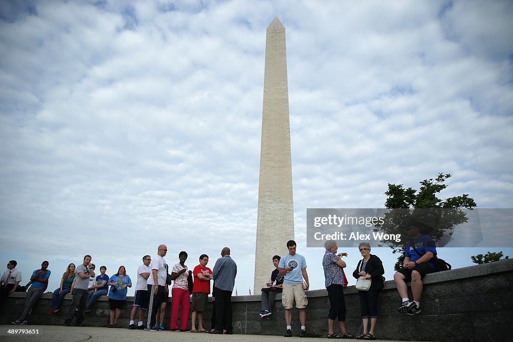 Visitors wait in-line for tickets to visit the Washington Monument ...
