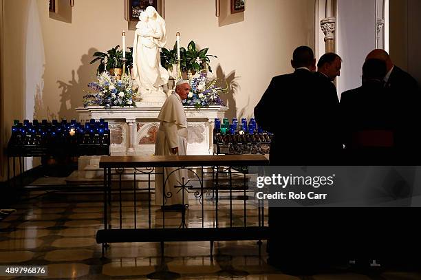 Pope Francis walks to the alter after praying during a visit to St. Patrick's Catholic Church on September 24, 2015 in Washington, DC. The Pope is on...