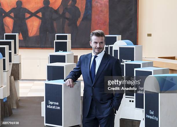 Goodwill Ambassador David Beckham poses amidst a digital installation at the unveiling of a digital installation that brings the voices of young...
