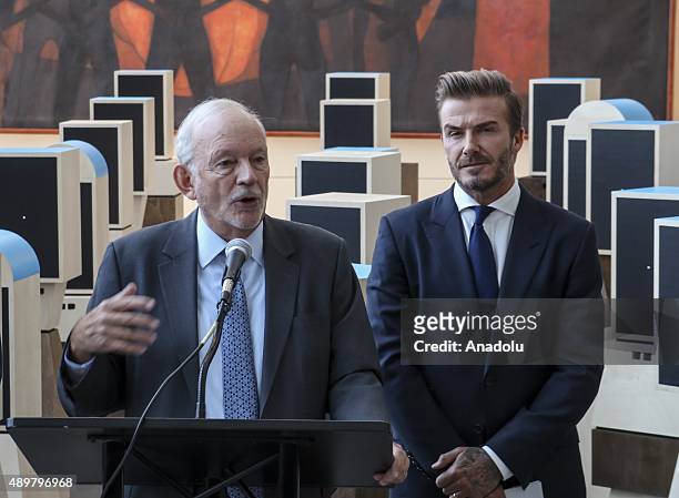 Goodwill Ambassador David Beckham listens as UNICEF Executive Director Anthony Lake speaks during the unveiling of a digital installation that brings...