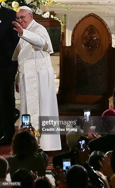 Pope Francis waves as he leaves after his visit at St. Patrick's Catholic Church September 24, 2015 in Washington, DC. The Pope is on his first trip...