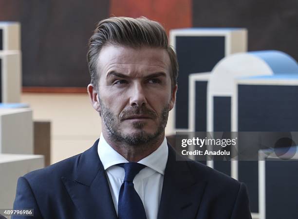 Goodwill Ambassador David Beckham poses amidst a digital installation at the unveiling of a digital installation that brings the voices of young...