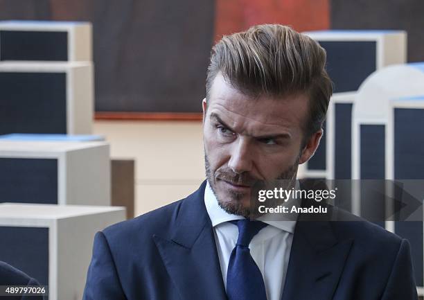 Goodwill Ambassador David Beckham poses amidst a digital installation at the unveiling of a digital installation that brings the voices of young...