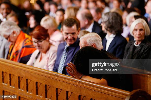 Woman prays while awaiting the arrivial of Pope Francis to St. Patrick's Catholic Church on September 24, 2015 in Washington, DC. The Pope is on a...