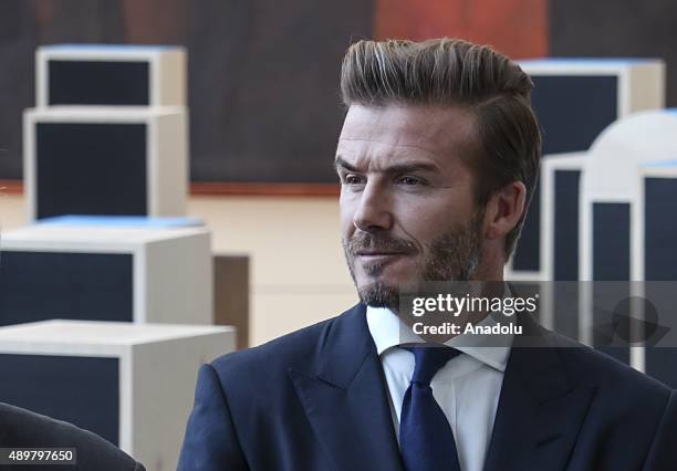 Goodwill Ambassador David Beckham poses amidst a digital installation at the unveiling of a digital installation that brings the voices of young...