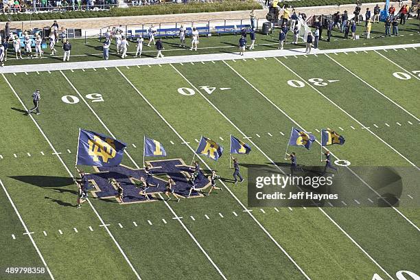 Aerial view of Notre Dame cheerleaders taking field with flags that spell out IRISH before game vs Georgia Tech at Notre Dame Stadium. South Bend, IN...