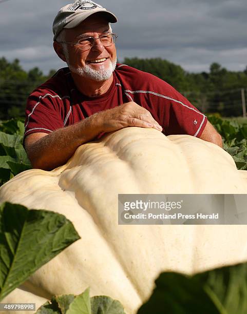 John Chandler with his giant pumpkins he grows at Springbrook Farm to show at the Cumberland Fair.