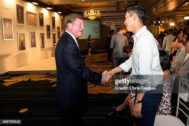 Southern Company CEO Tom Fanning greets Sangmoon Bae of Korea during the Payne Stewart Award ceremony for Ernie Els, held following practice for the...