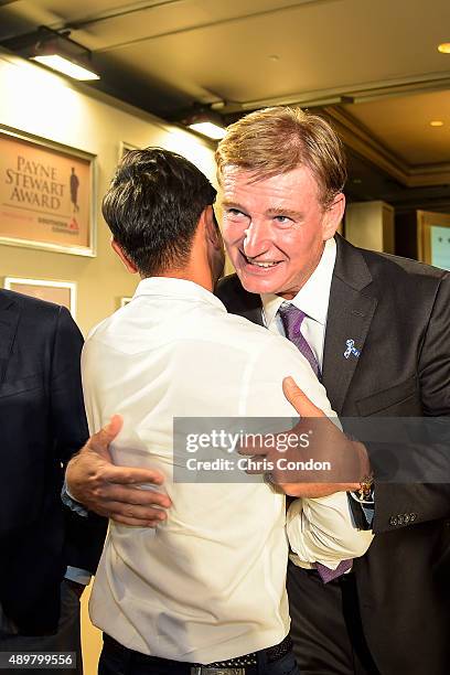 Ernie Els hugs Sangmoon Bae of Korea after Els received the Payne Stewart Award during a ceremony held following practice for the TOUR Championship...