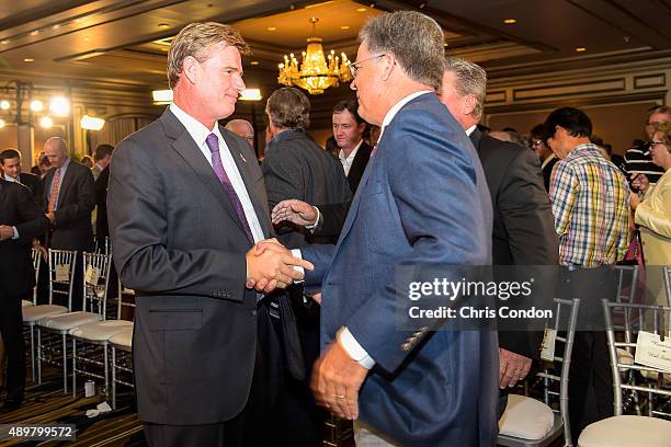 Ernie Els greets Kenny Perry after Els received the Payne Stewart Award during a ceremony held following practice for the TOUR Championship by...