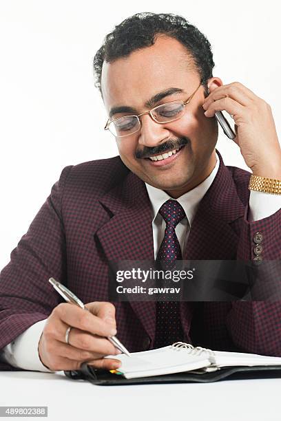 happy confident businessman doing his work while talking on phone. - brown moustache cutout stockfoto's en -beelden