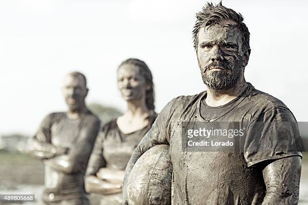 team posing for a group pic in the mud - rugby team stock pictures, royalty-free photos & images