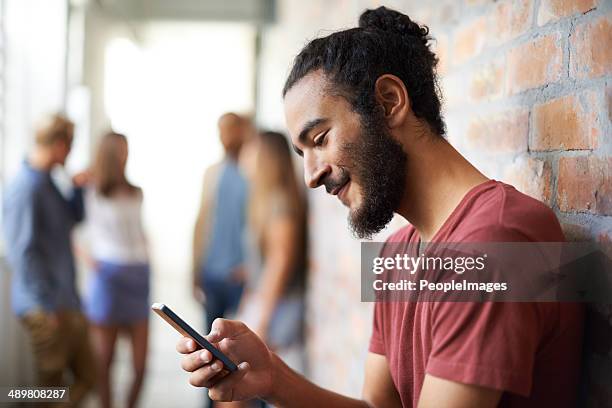 arranging a date for the weekend - man looking at phone in public stock pictures, royalty-free photos & images