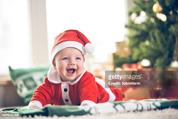 cute christmas baby boy - santa claus lying stockfoto's en -beelden