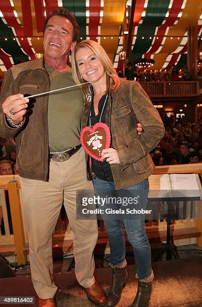 Arnold Schwarzenegger and his partner Heather Milligan visit the Schuetzenfestzelt during the Oktoberfest 2015 at Theresienwiese on September 24,...