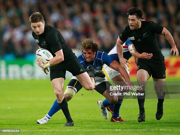 Beauden Barrett of the New Zealand All Blacks breaks past Jacques Burger of Namibia on the way to scoring his teams fourth try during the 2015 Rugby...