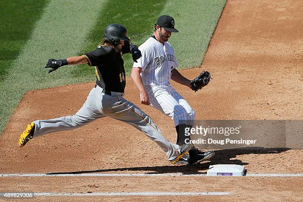 Starting pitcher Chad Bettis of the Colorado Rockies gets a put out on Jaff Decker of the Pittsburgh Pirates at first after first baseman Wilin...