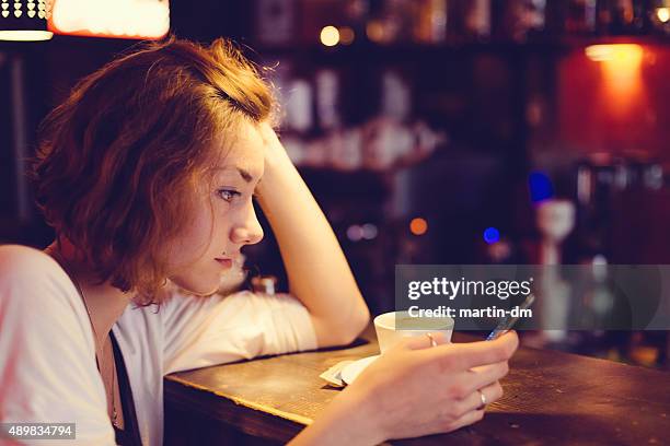 teenage girl using smartphone in a cafe - bar girl stock pictures, royalty-free photos & images