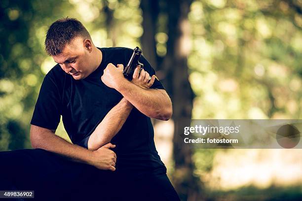 self-defending from attacker with handgun - self defence stock pictures, royalty-free photos & images