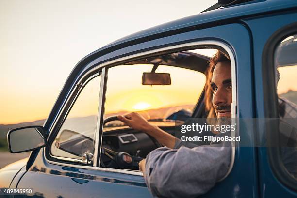 young couple trip with vintage car - car sunset arm stock pictures, royalty-free photos & images