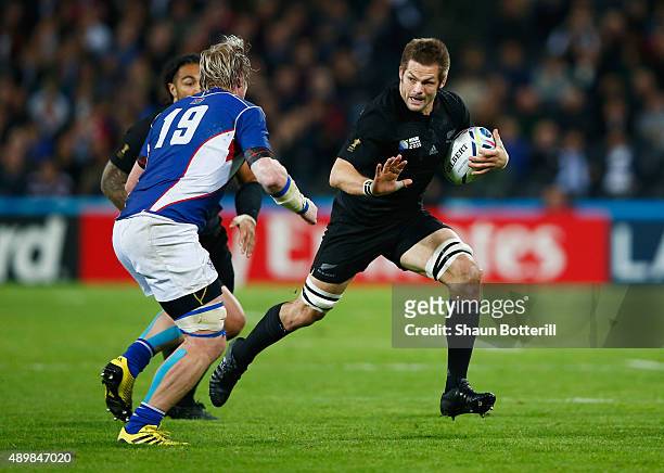 Richie McCaw of the New Zealand All Blacks takes on Renaldo Bothma of Namibia during the 2015 Rugby World Cup Pool C match between New Zealand and...