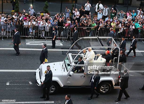 Pope Francis is viewed from a window at the St. Regis Hotel as he makes his way down 5th Avenue towards St. Patricks Cathedral on September 24, 2015...