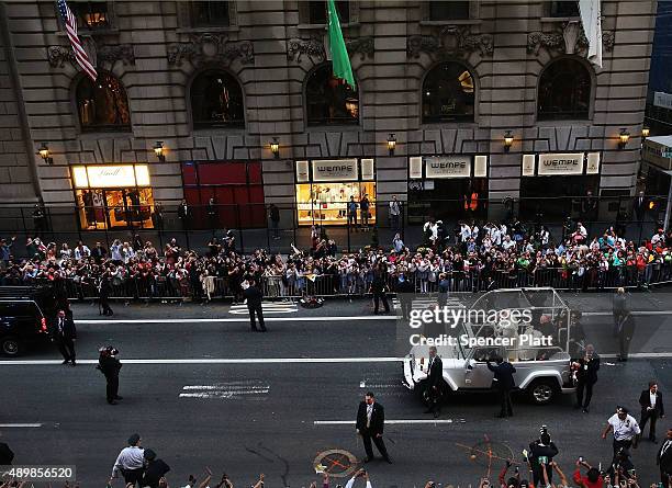 Pope Francis is viewed from a window at the St. Regis Hotel as he makes his way down 5th Avenue towards St. Patricks Cathedral on September 24, 2015...