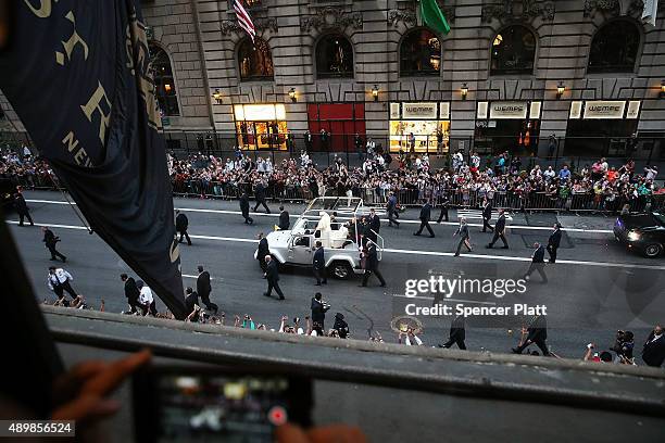 Pope Francis is viewed from a window at the St. Regis Hotel as he makes his way down 5th Avenue towards St. Patricks Cathedral on September 24, 2015...