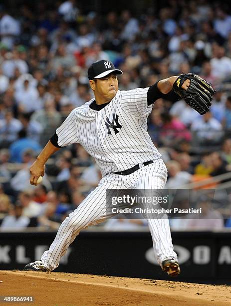 Hiroki Kuroda of the New York Yankees throws a pitch in the top of the second inning during the game against the New York Mets at Yankee Stadium on...