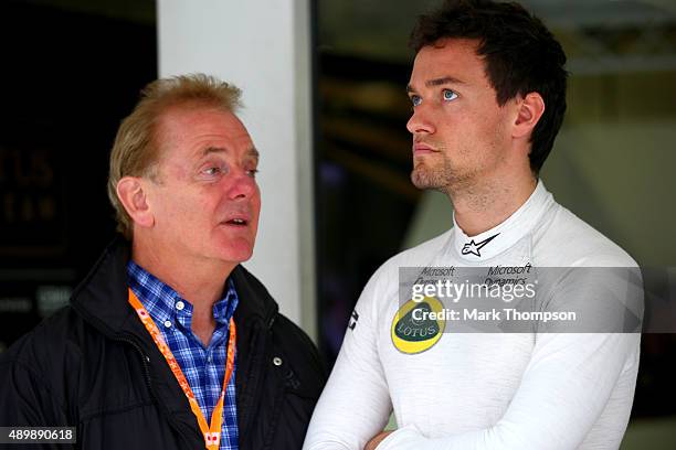 Jolyon Palmer of Great Britain and Lotus speaks with his father Jonathan Palmer outside the team garage during practice for the Formula One Grand...