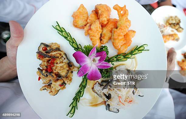 This photo taken on September 24, 2015 shows a dish made from Chinese giant salamanders on display at a food festival in Zhangjiajie, central China's...