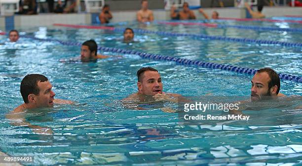 Jason King, Anthony Watmough and Brett Stewart warm up during a Manly Sea Eagles NRL pool session at Warringah Aquatic Centre on May 13, 2014 in...