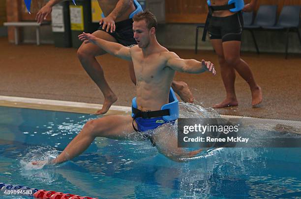 Daly Cherry Evans jumps into the water during a Manly Sea Eagles NRL pool session at Warringah Aquatic Centre on May 13, 2014 in Sydney, Australia.