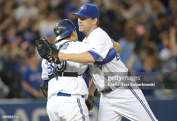 Casey Janssen of the Toronto Blue Jays celebrates a victory with Dioner Navarro during MLB game action against the Los Angeles Angels of Anaheim on...