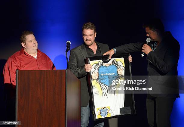 Comedian Ralphie May, Honoree Rob Beckham of WME, and Storme Warren speak onstage during the T.J. Martell Ambassador Of The Year Awards at The...