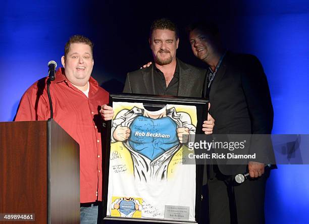 Comedian Ralphie May, Honoree Rob Beckham of WME, and Storme Warren speak onstage during the T.J. Martell Ambassador Of The Year Awards at The...