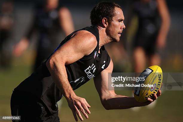 Ben Hudson looks ahead with the ball during a Collingwood Magpies AFL training session at Olympic Park on May 13, 2014 in Melbourne, Australia.