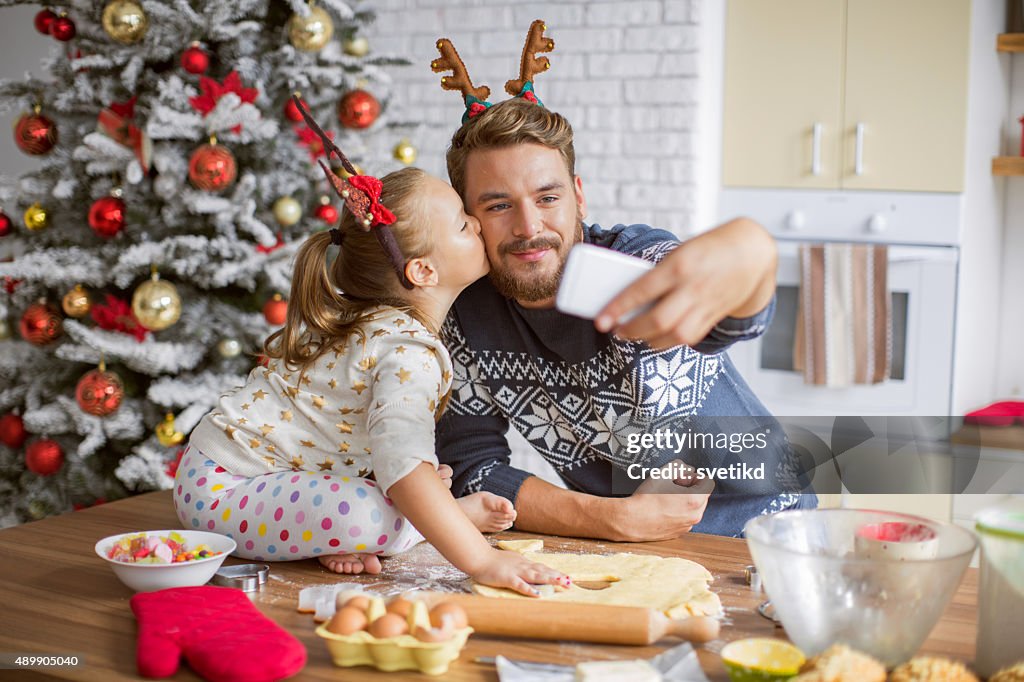 Father and daughter baking in kitchen for christmas.