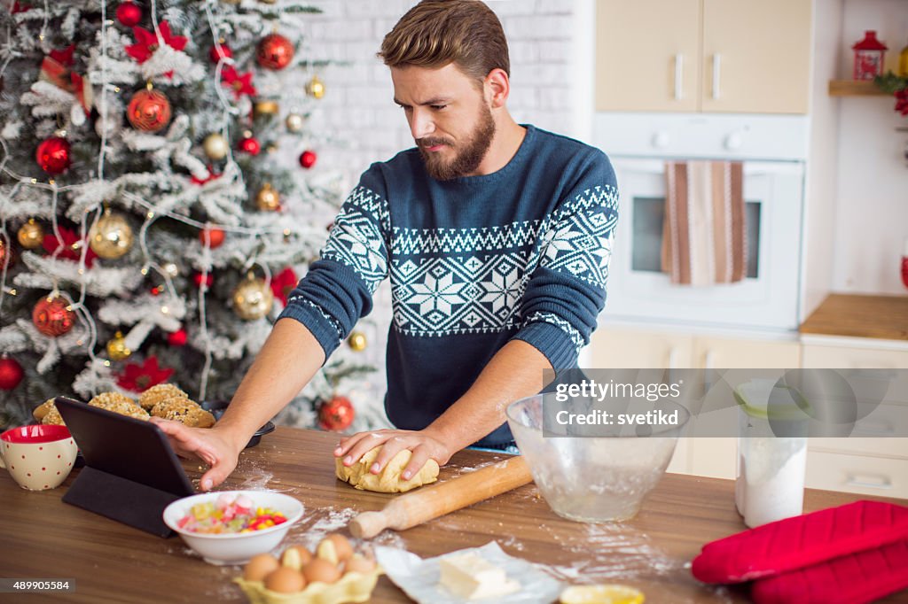 Man baking in kitchen for christmas.